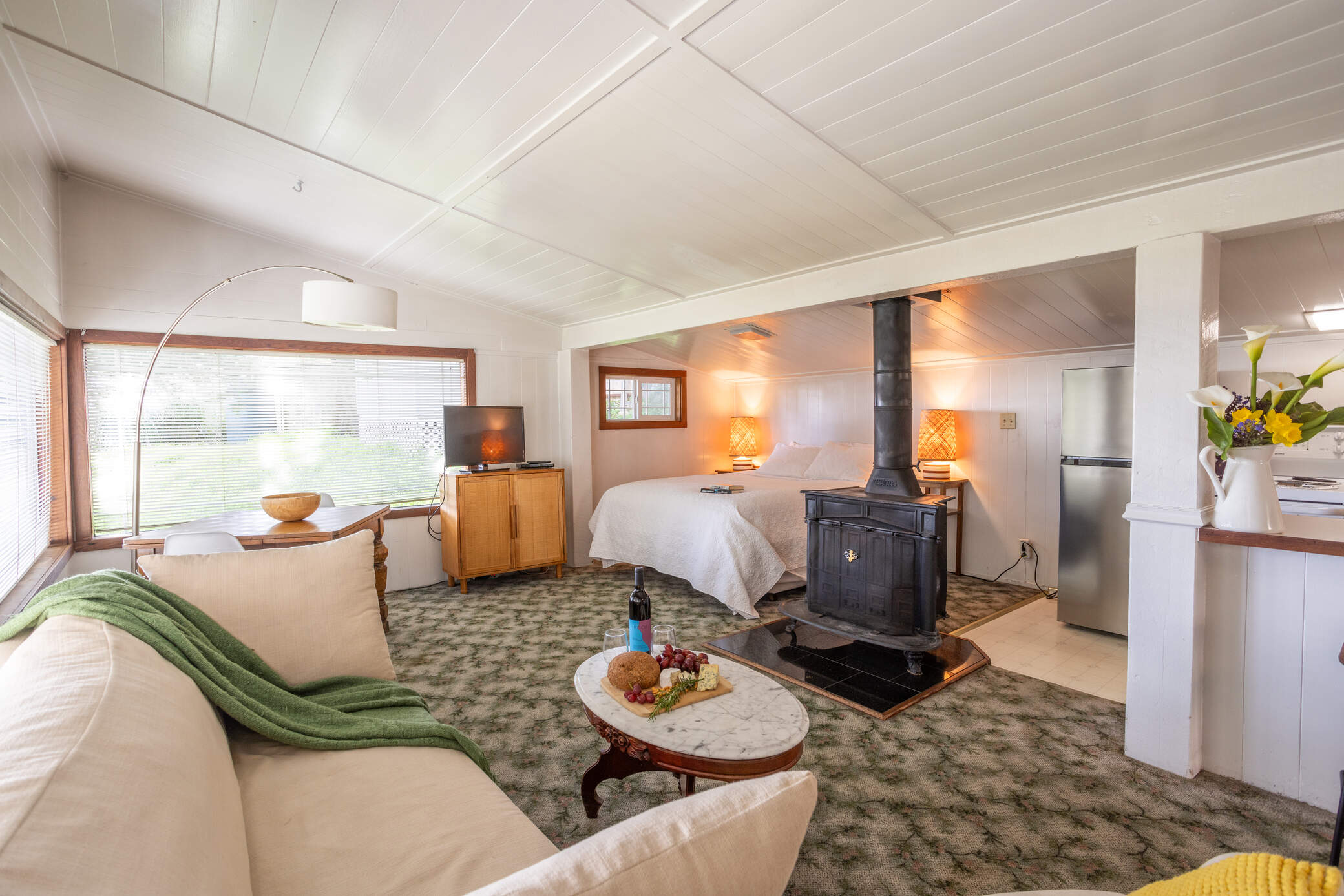 Mendocino Cottages - Quail Cottage couch, fireplace and bed